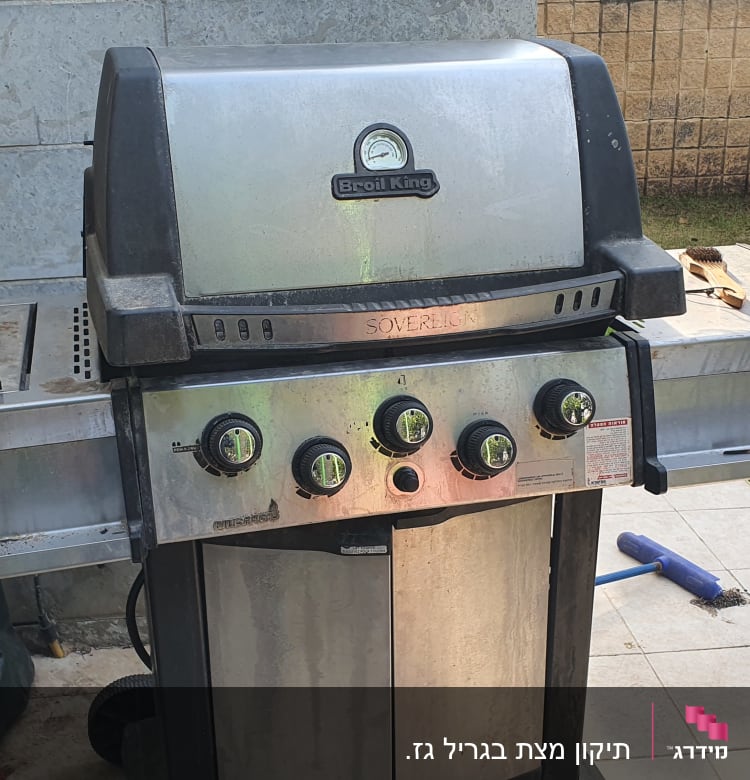 גריל גז עם כפתורים ומד חום בחצר